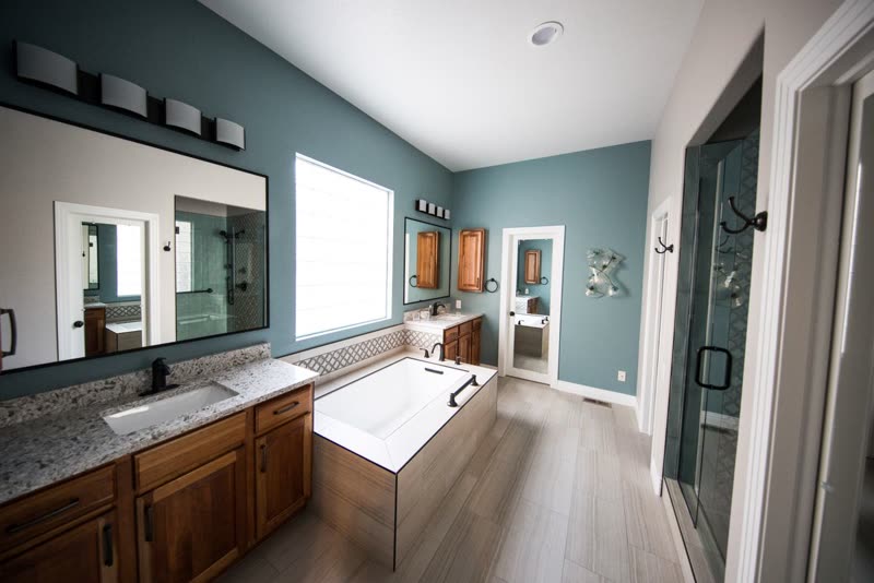 Remodelled bathroom with a wood vanity, soaking tub and tiled shower